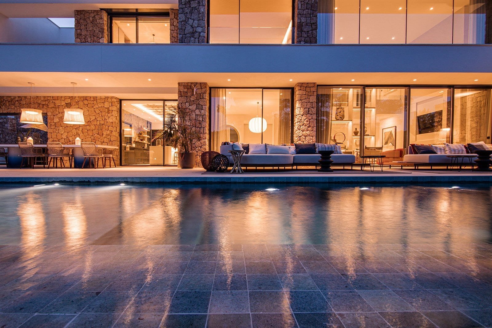 Luxury Ibiza villa with pool, modern architecture, and stunning sunset views.