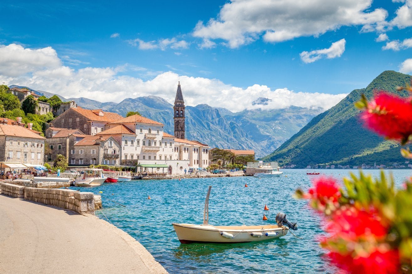 Beautiful lakeside village featuring historic buildings and a prominent church tower, set against st.