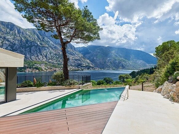 Sea view villa in Prčanj with infinity pool and mountain backdrop.