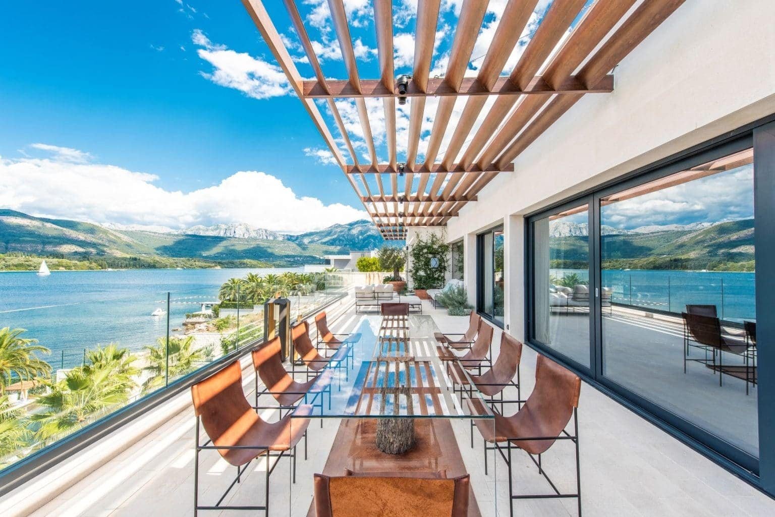 Waterfront penthouse terrace with panoramic views in Tivat, Montenegro, featuring modern outdoor sea.