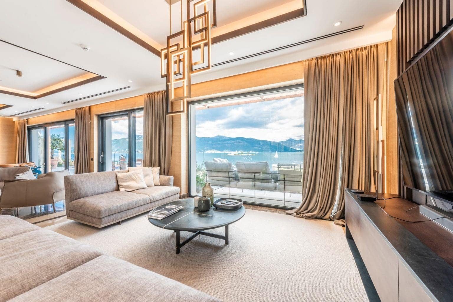 Elegant waterfront penthouse living room with panoramic sea views in Nikki Beach Montenegro.