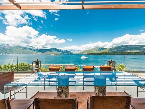 Waterfront penthouse terrace with stunning lake and mountain scenery in Tivat, Montenegro.