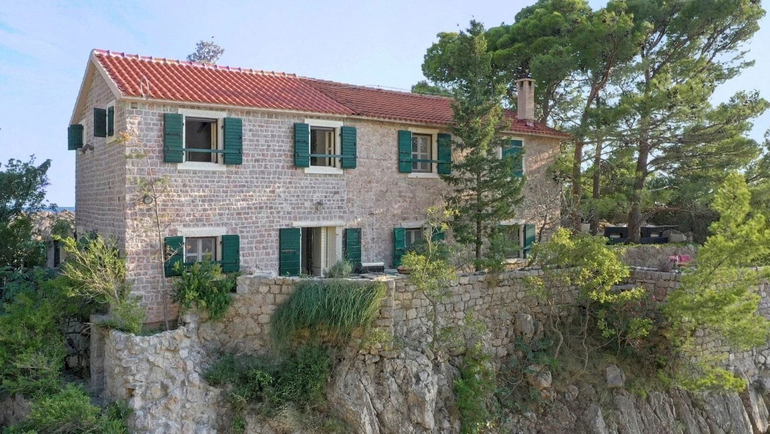 Elegant stone estate on Montenegro's coast with lush gardens and panoramic sea views.