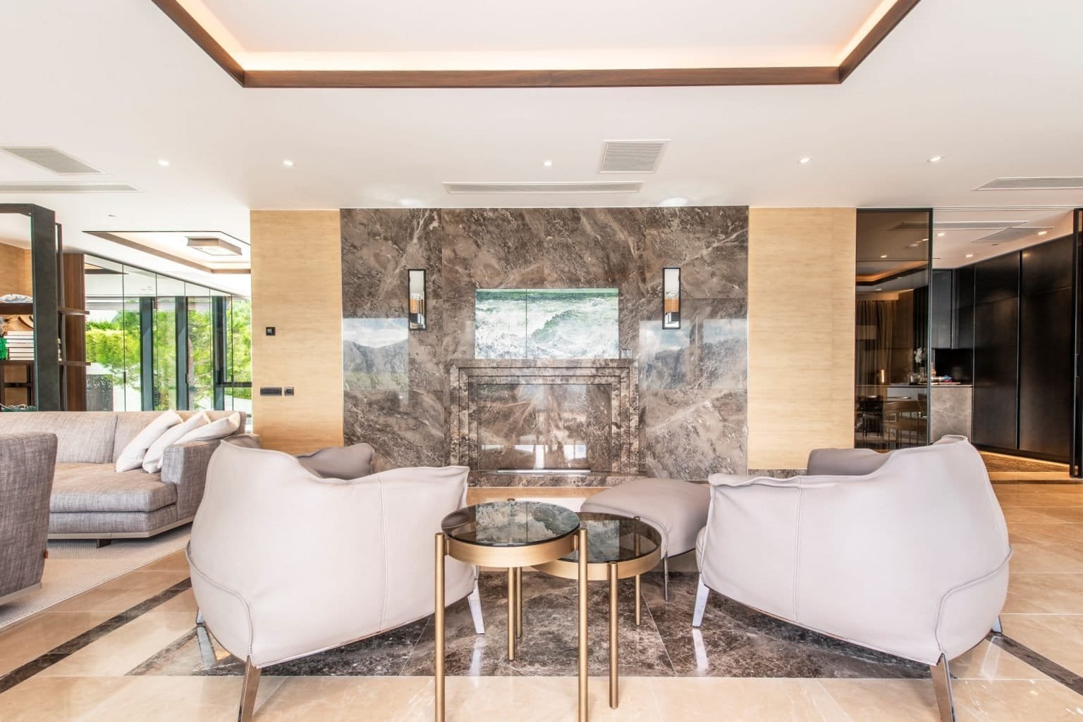 Elegant hotel lobby with marble fireplace and contemporary furniture.