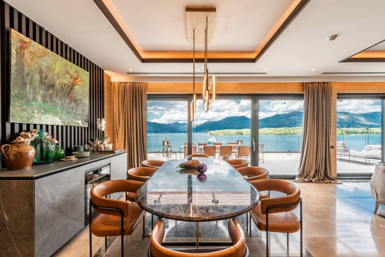 Luxury waterfront dining room with panoramic sea views in Tivat, Montenegro, featuring elegant decor.