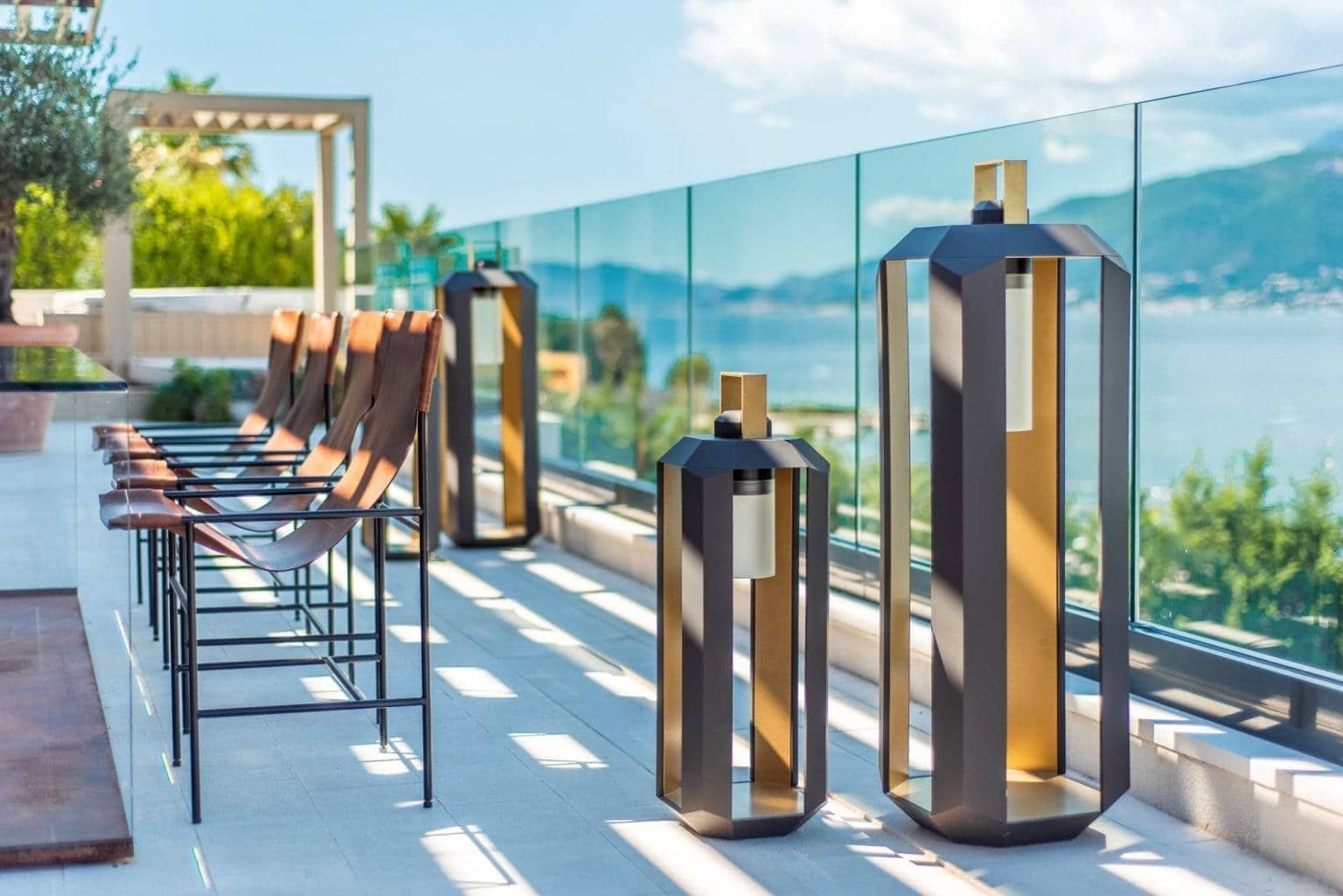 Luxury waterfront terrace with modern seating and lighting, overlooking Nikki Beach Montenegro in Ti.