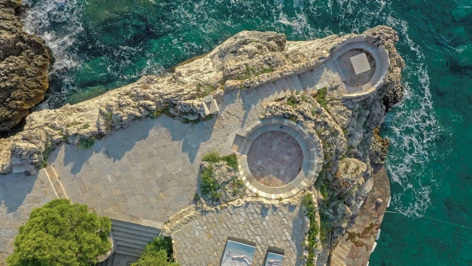 Aerial view of a luxurious Montenegro estate on the Reževići peninsula with scenic coastal surroundi.