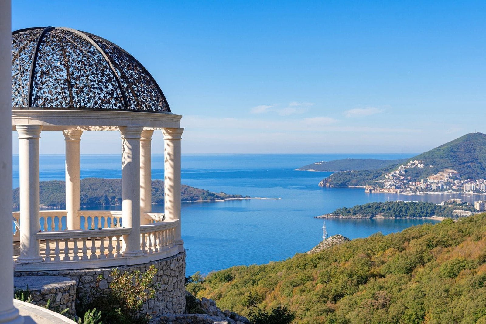 Luxury seaside property with scenic views of the coast and mountains.