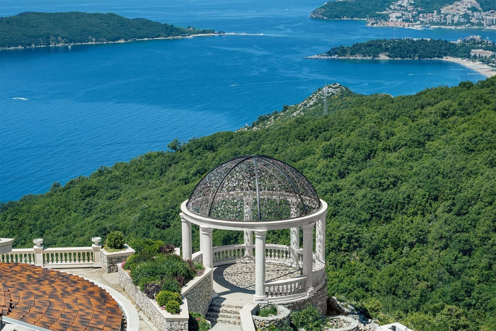 Elegant gazebo overlooking the ocean with panoramic water and forest views.