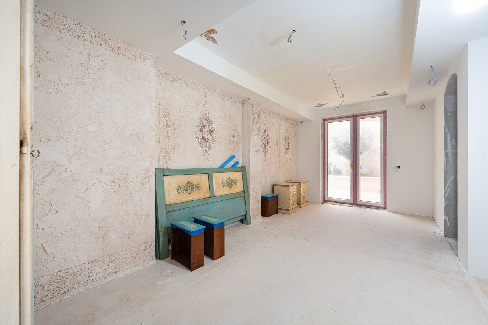 Interior of a spacious, unfinished room with exposed walls and ceiling, awaiting finishing touches a.
