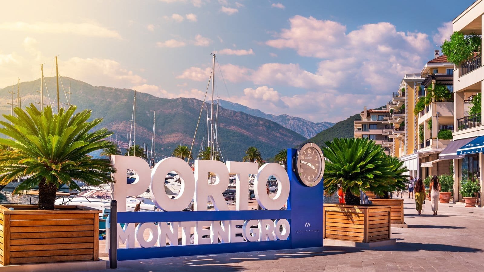 Scenic view of Porto Montenegro marina with luxury apartments and yachts.