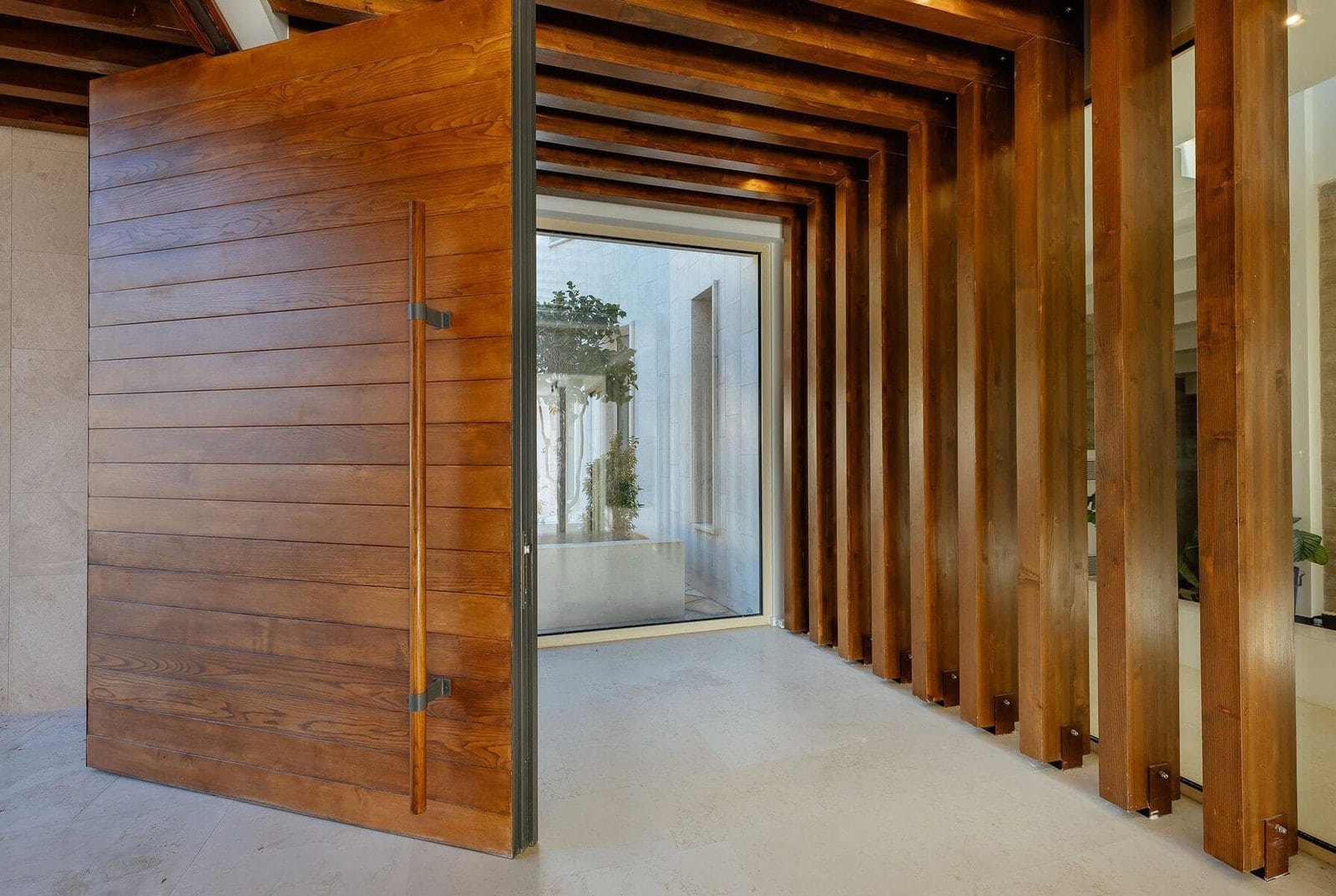 Contemporary wooden entrance with slatted design at Barok Estates International.