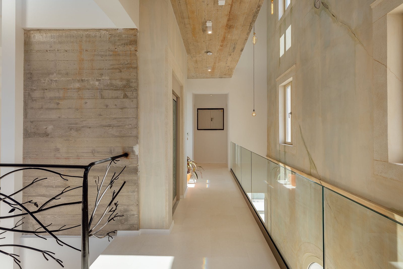 Bright, minimalist hallway with natural light and contemporary design elements at Barok Estates Inte.