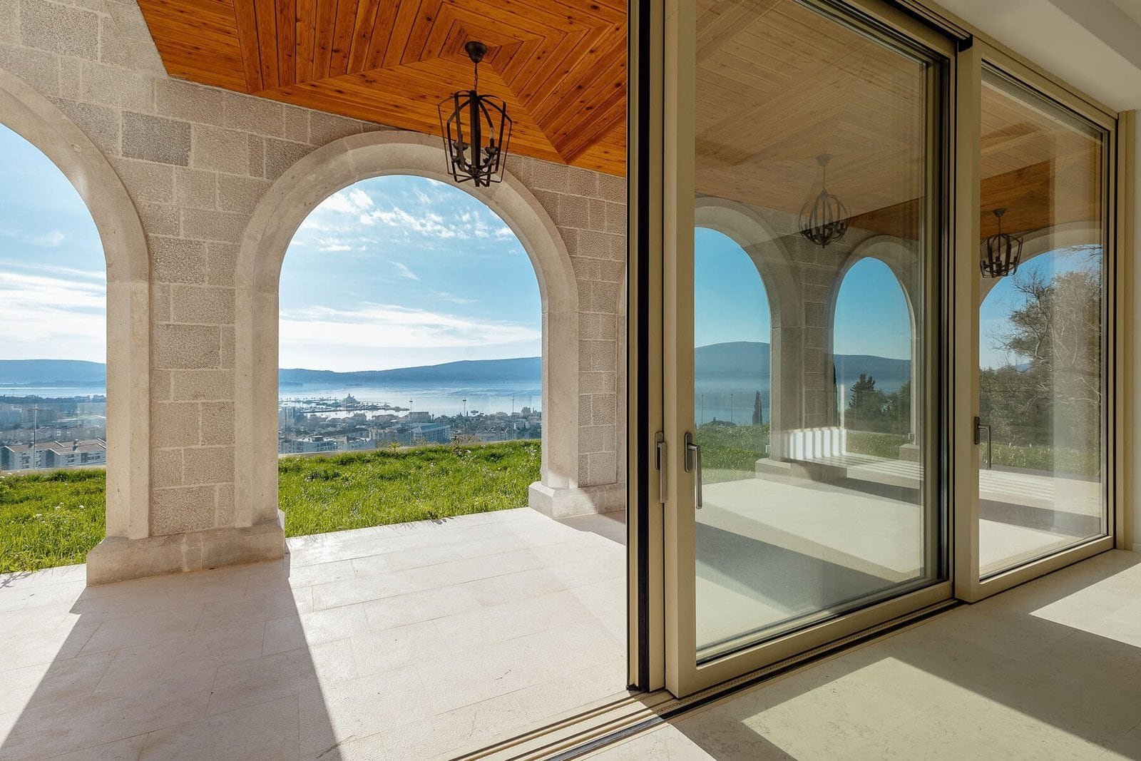 Elegant villa with panoramic mountain views and a large outdoor terrace.