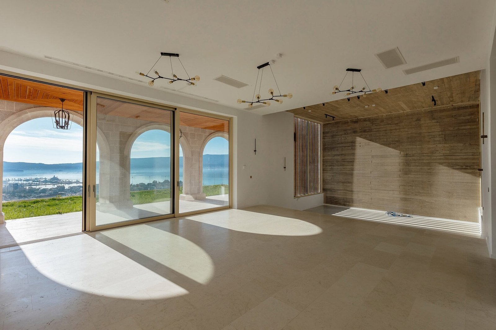 Luxury living room with panoramic water views and spacious open-plan design.