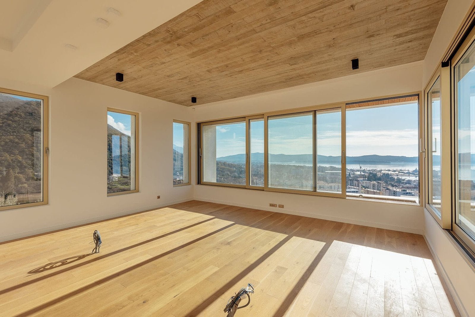 Panoramic view of waterfront cityscape from modern apartment.