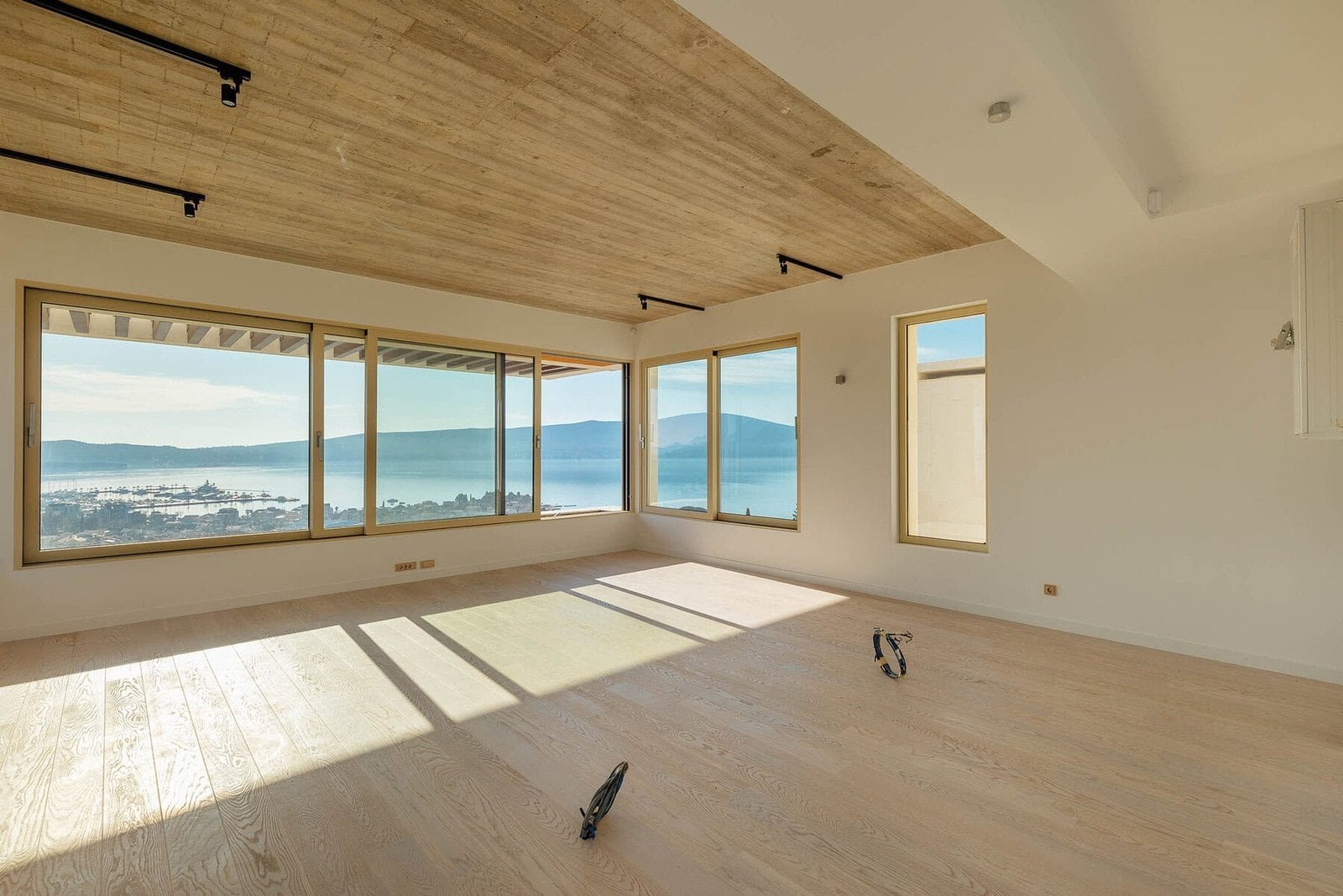 Panoramic view of waterfront apartment with large windows and natural light.