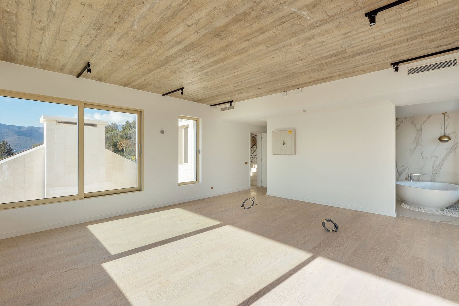 Spacious interior featuring large windows, natural sunlight, and contemporary design elements for lu.