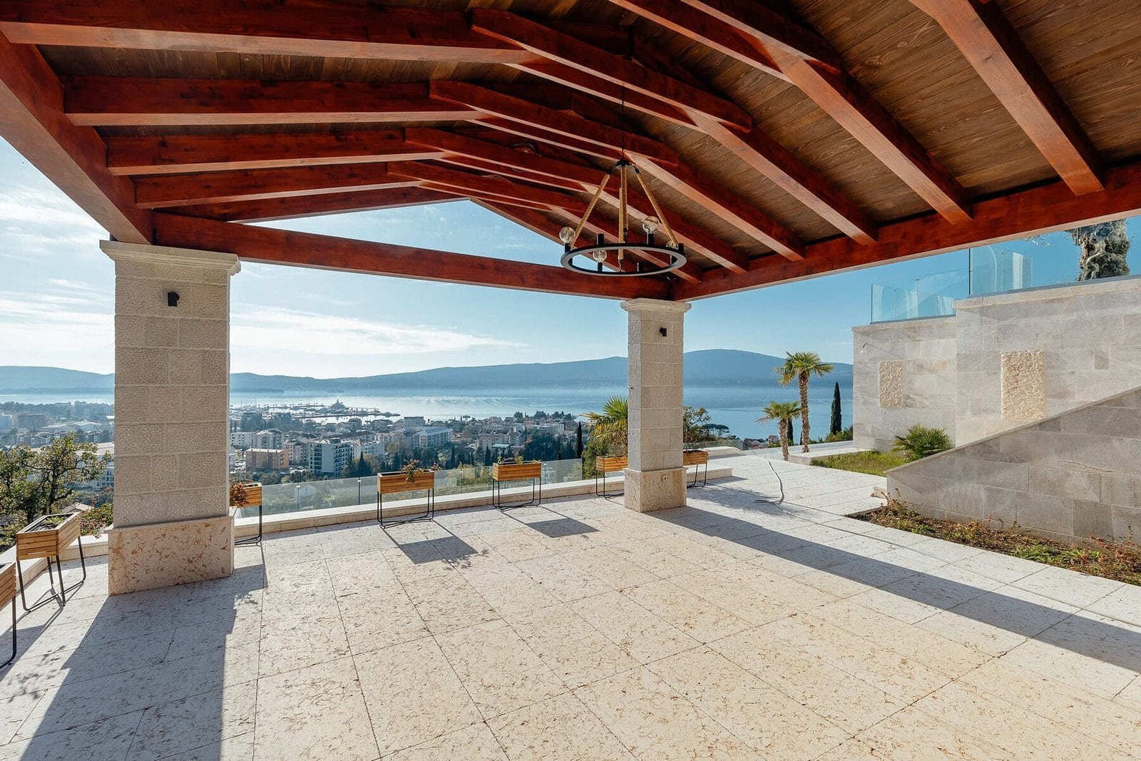 Spacious outdoor terrace featuring a wooden roof and panoramic city and mountain vistas, ideal for u.