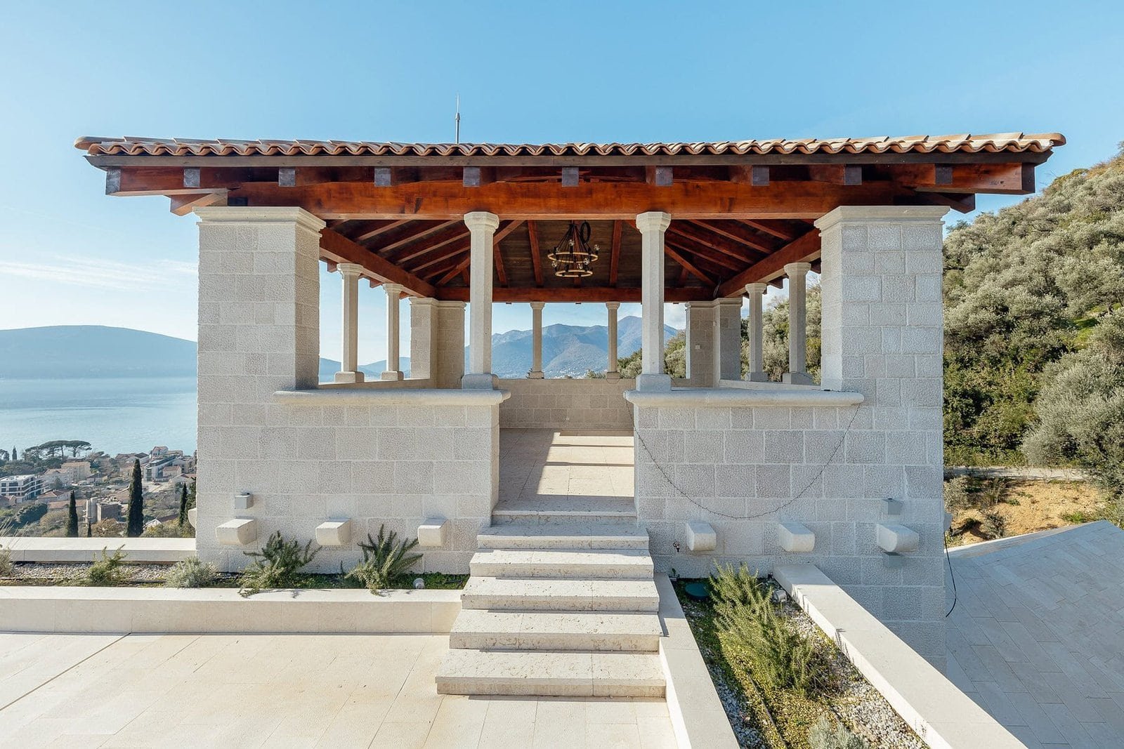 Luxury villa terrace with scenic views and Mediterranean architecture, featuring stone columns and a.