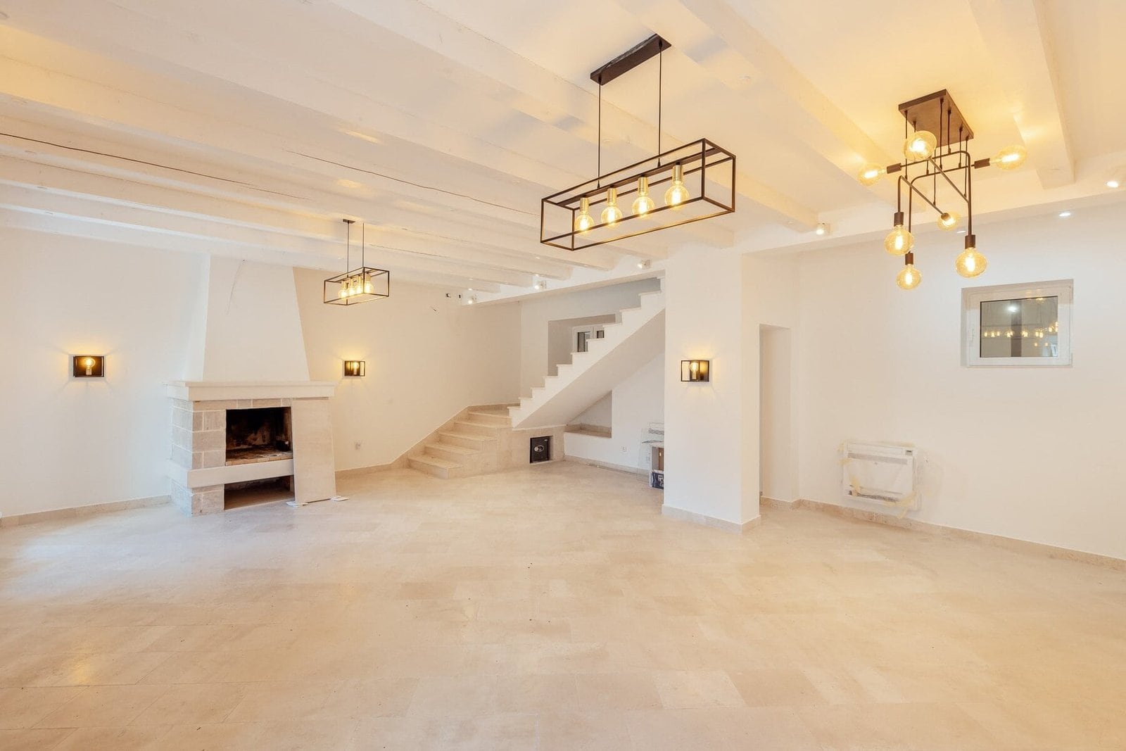 Elegant modern living room with stylish lighting fixtures and spacious design.