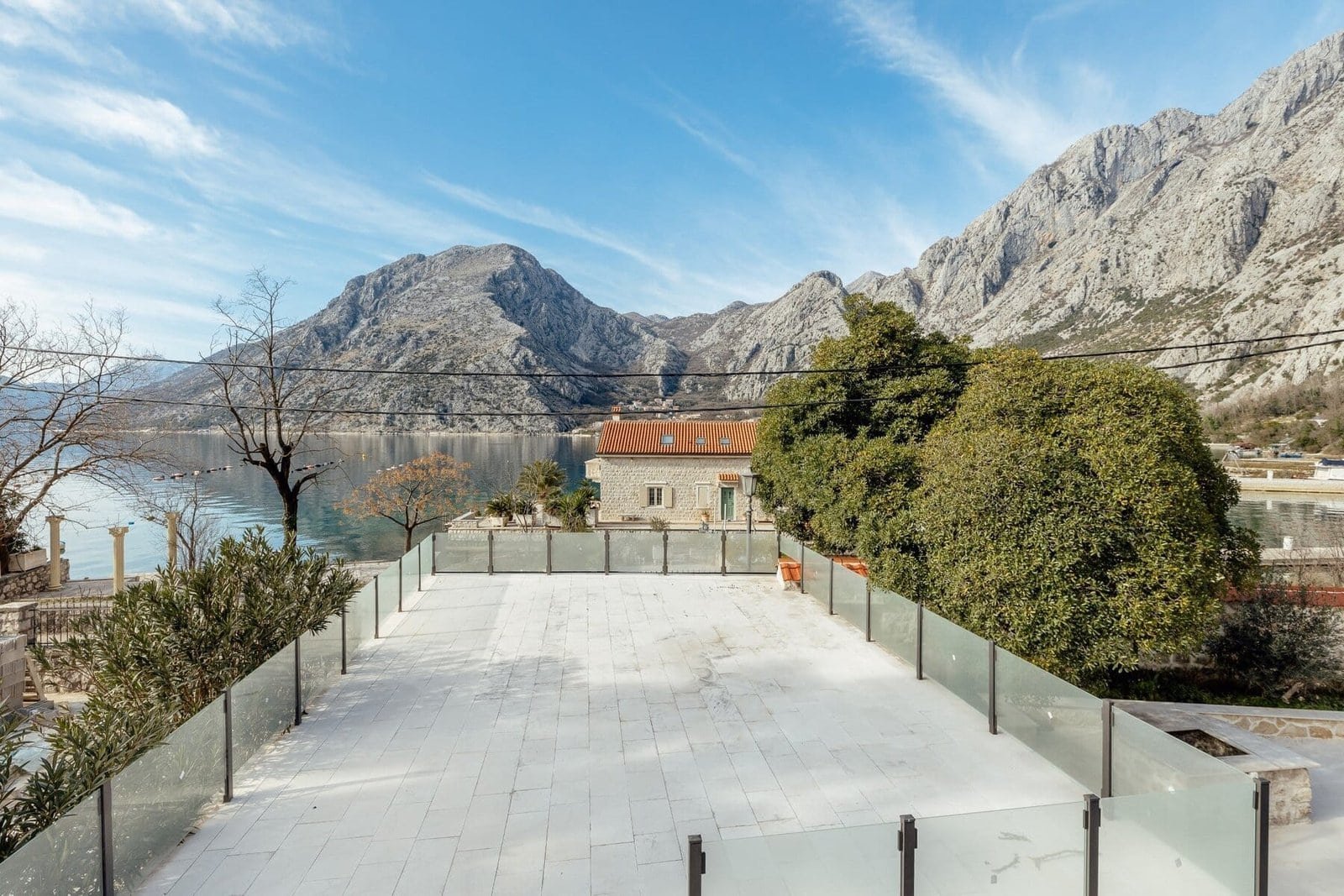 Beautiful waterfront property with stunning mountain scenery and clear blue skies.