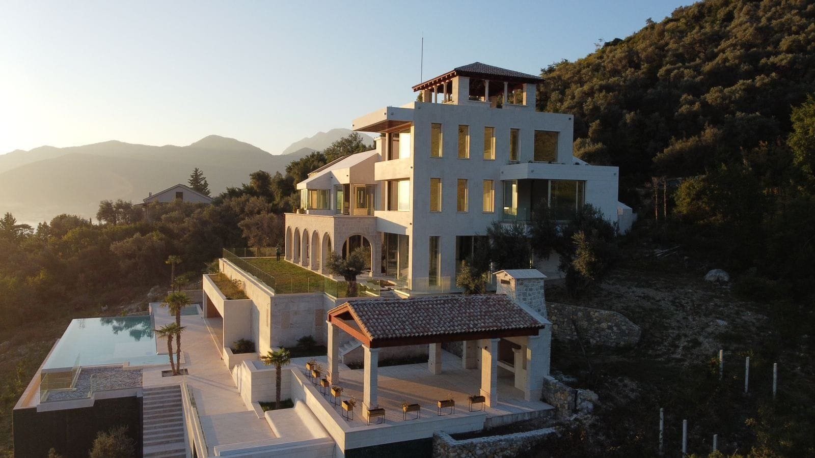 Luxury mountain villa with infinity pool overlooking scenic hills.