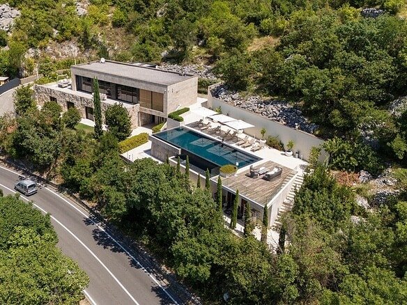 Luxury villa featuring a private pool and modern architecture nestled among lush greenery.