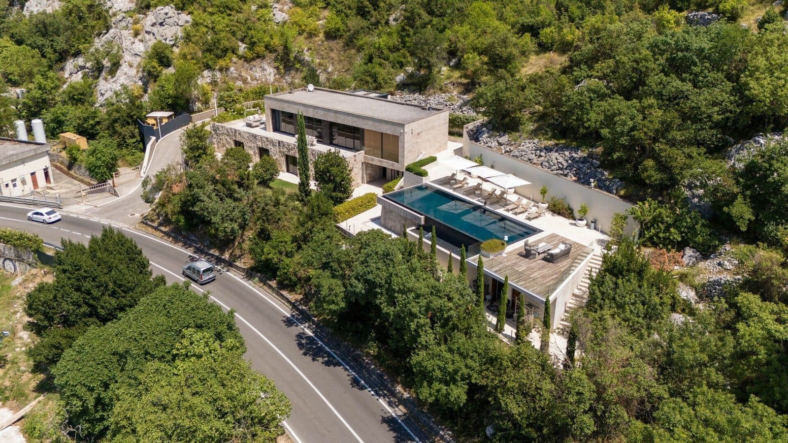Luxury villa featuring a private pool and modern architecture nestled among lush greenery.