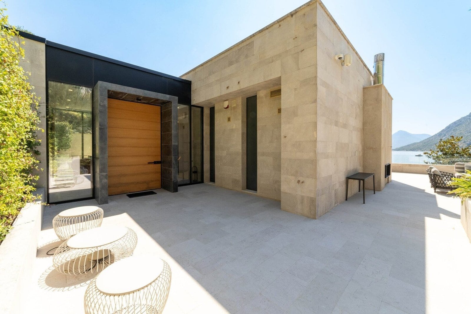 Luxury lakeside villa with contemporary architecture and scenic mountain views.