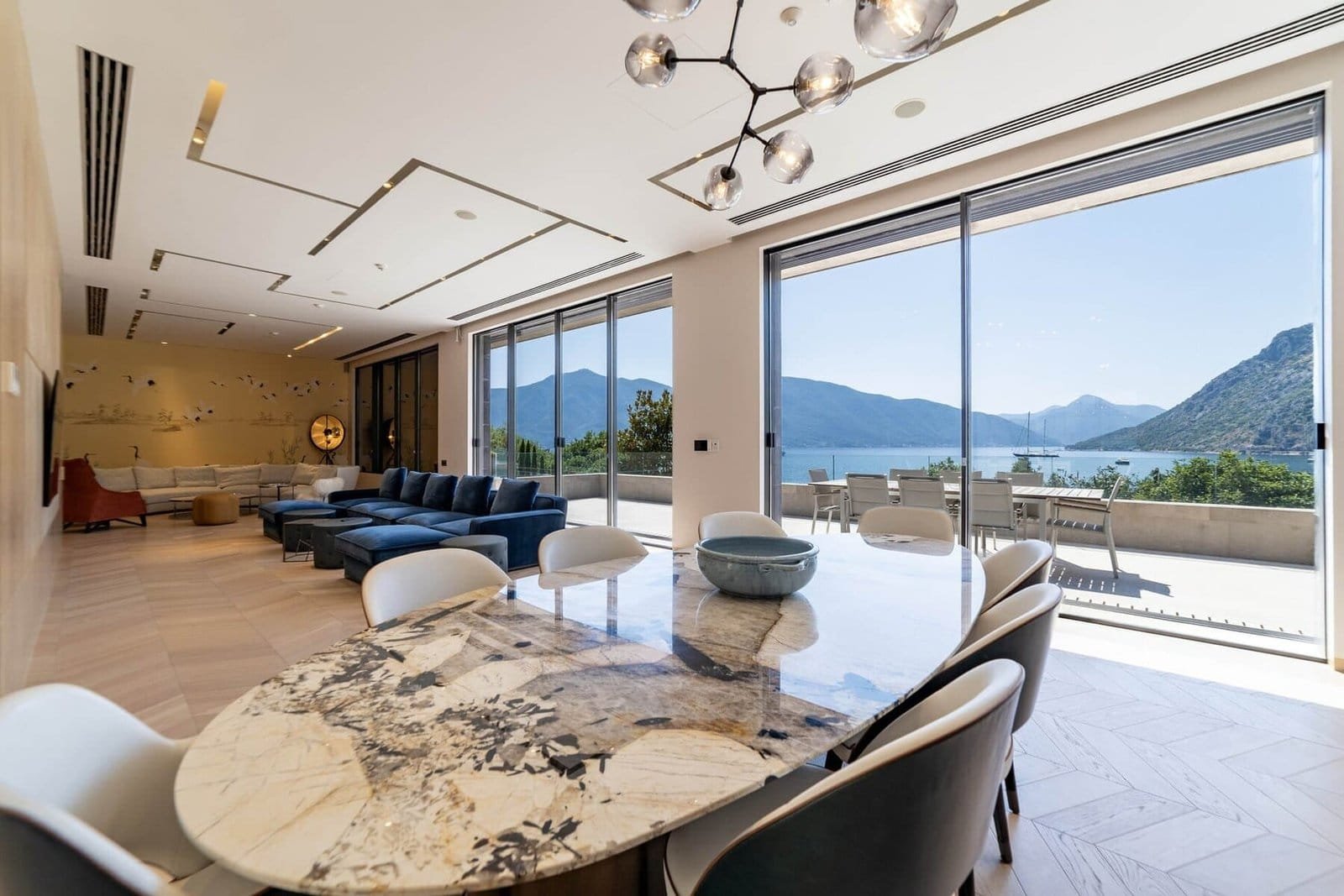 Luxury living room with mountain views, modern decor, and spacious seating area.