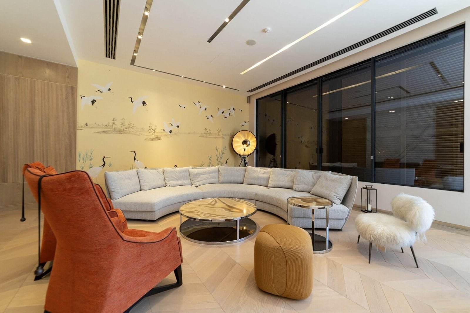 Living room with modern furniture and large windows.
