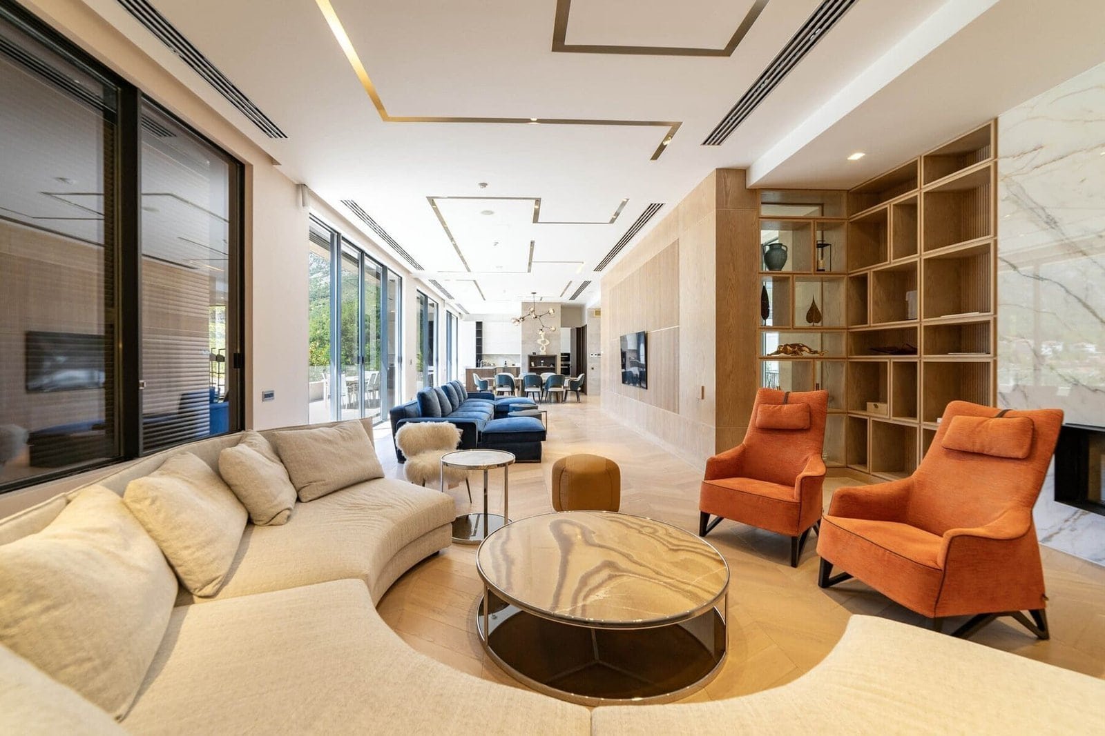 Elegant interior featuring comfortable sofas, armchairs, and contemporary decor in a spacious living.