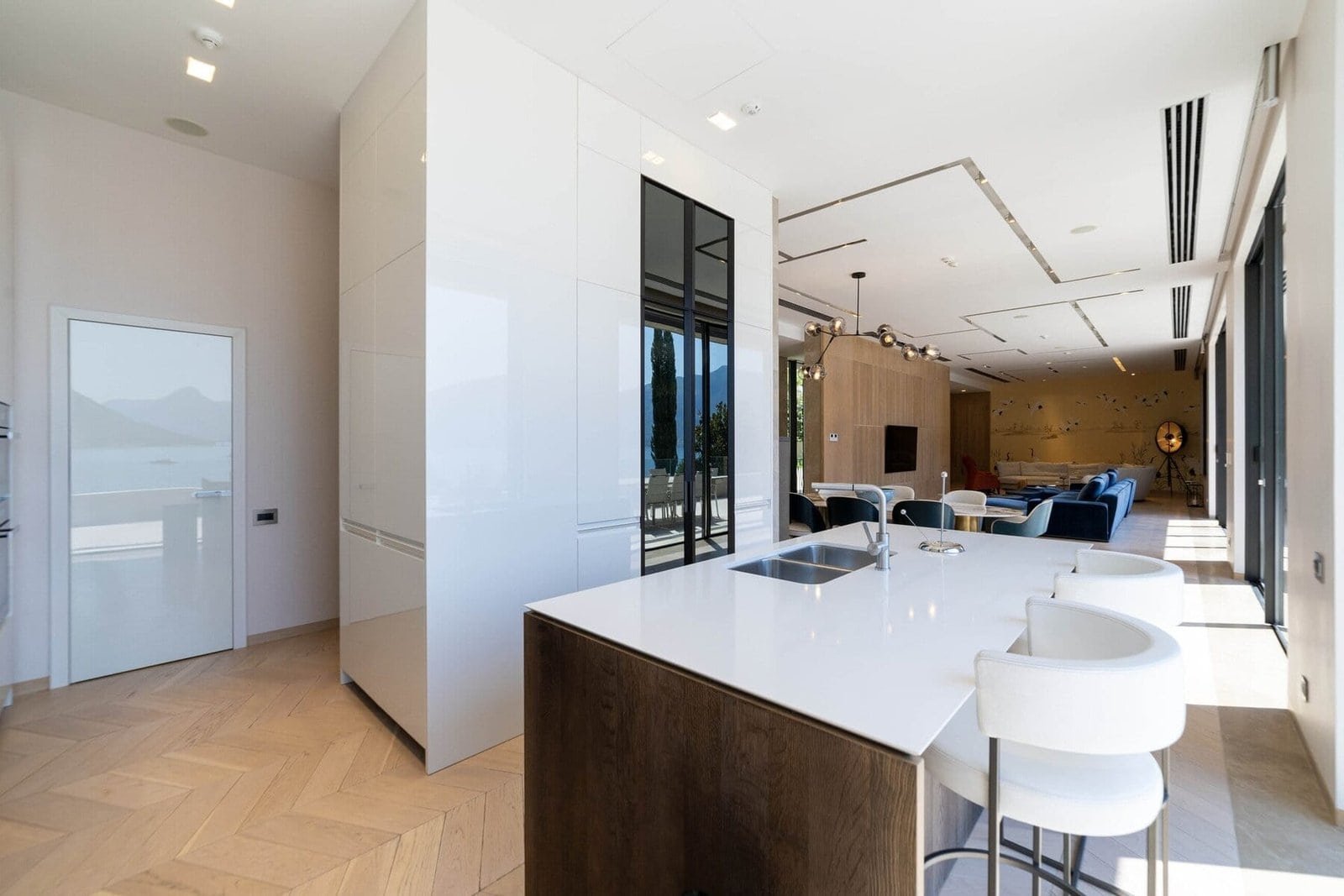 Luxury open-concept kitchen and living area with sleek design and modern furnishings.