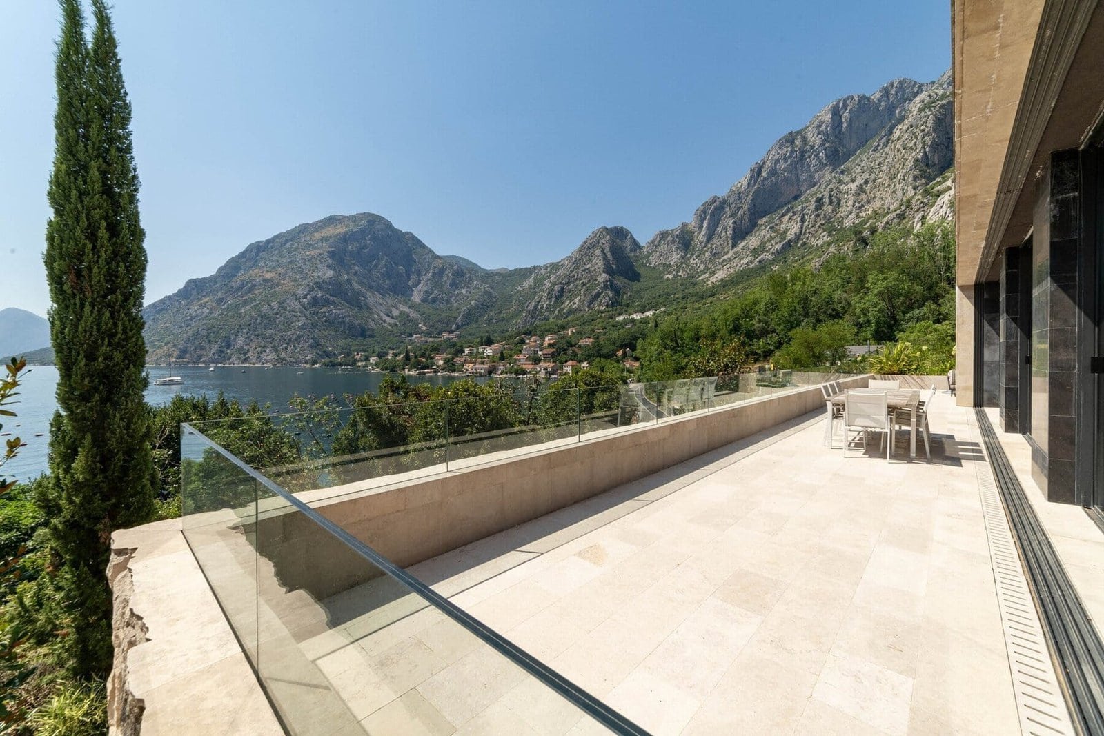 Spacious terrace with stunning mountain and lake views in a luxury estate.