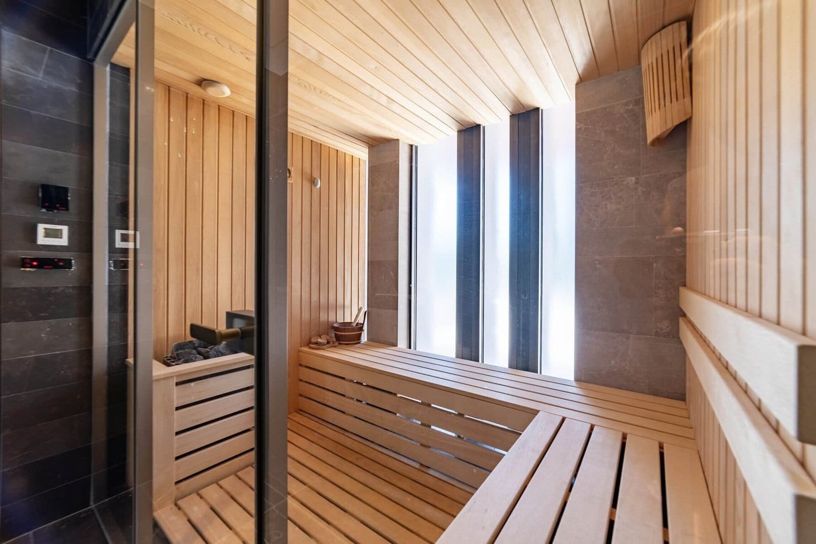 Luxury sauna room with wooden benches and modern design at Barok Estates International.