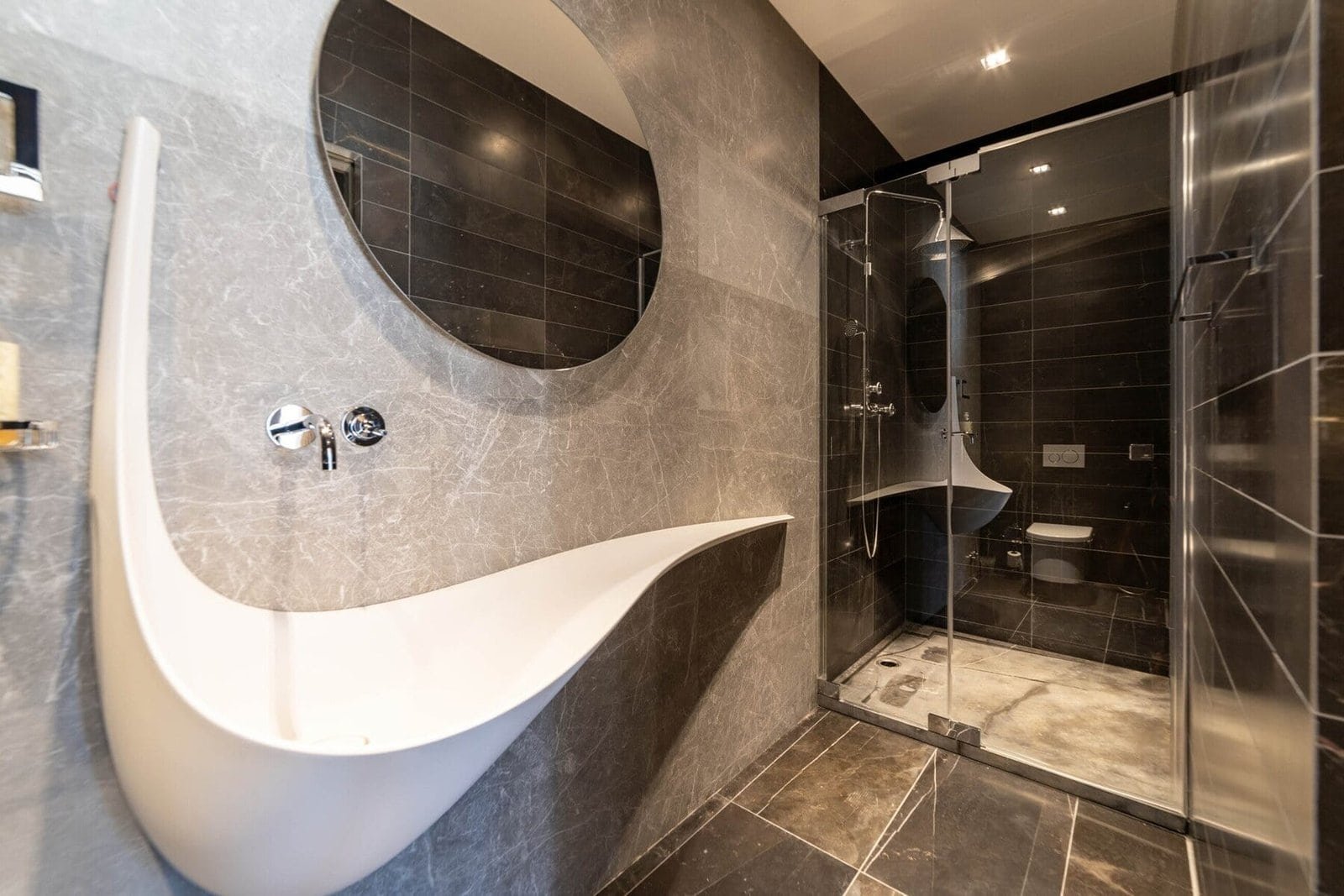 Elegant bathroom featuring contemporary design, stylish fixtures, and a spacious glass shower.