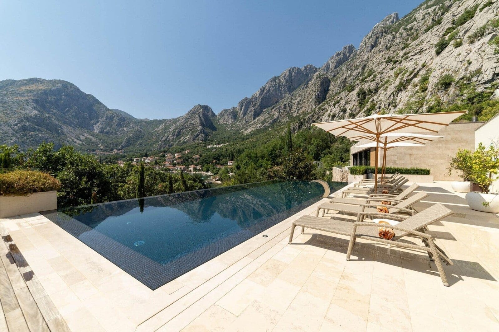 Infinity pool overlooking scenic mountain landscape at luxury villa.
