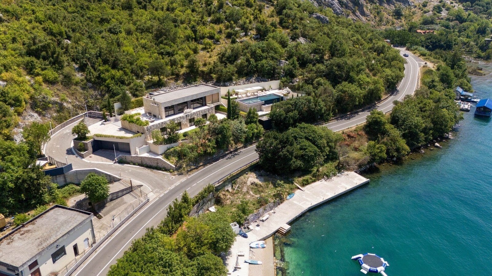 Luxury waterfront estate with scenic mountain views and private access to the water.