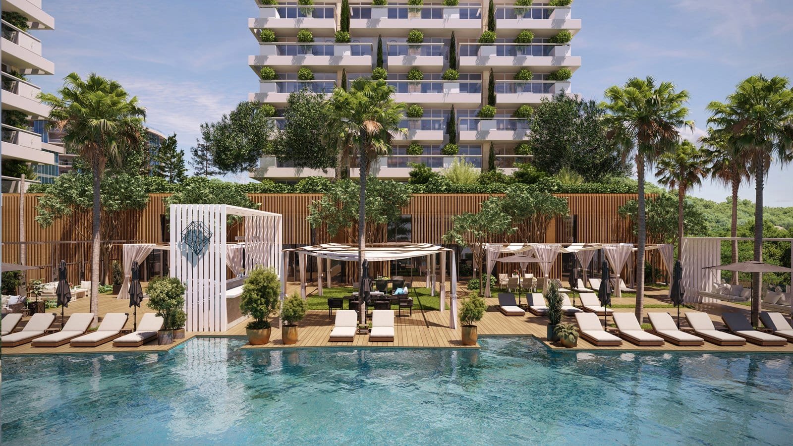 Poolside lounge area with sunbeds, umbrellas, and lush greenery at Barok Estates International.