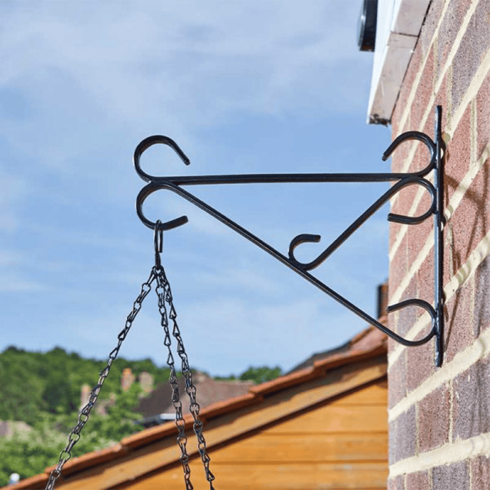 Black metal hanging basket bracket for garden and patio decor.