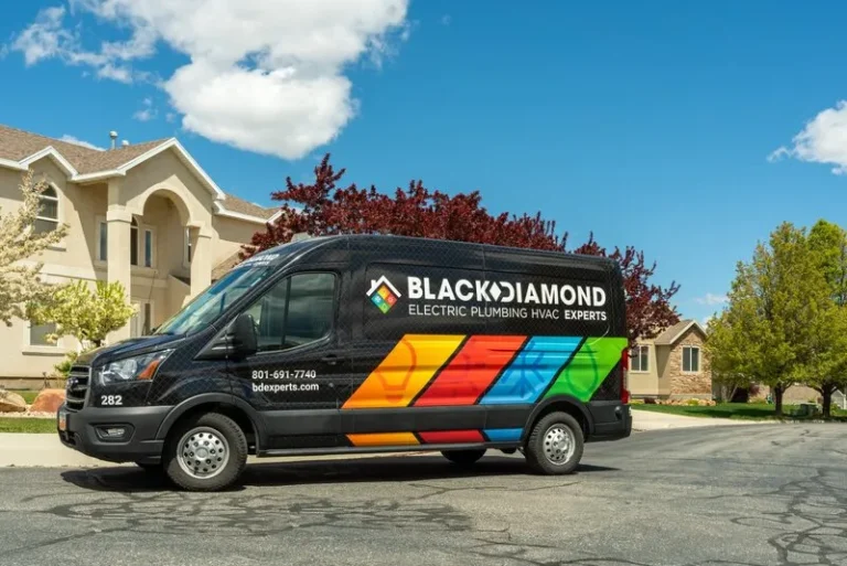 A Black Diamond Experts van with vibrant stripes, ready for 24/7 plumbing, HVAC, electrical, and drain service on a peaceful Utah street.