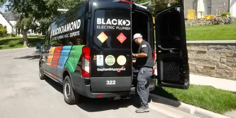 A trusted Black Diamond expert prepares by their van for a water filtration install, offering Utah homes 24/7 comfort and peace of mind.