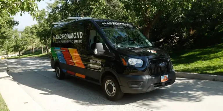 A Black Diamond service van, showcasing water filtration services, sits on a quiet street—trusted 24/7 experts in home comfort.