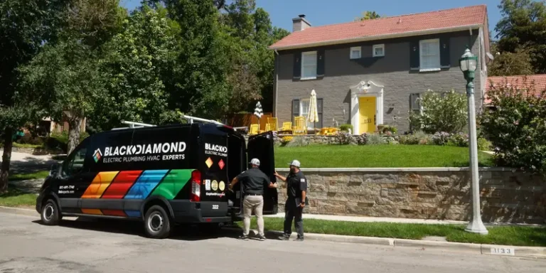 Friendly Black Diamond Experts, ready to provide trusted 24/7 home repair—plumbing, HVAC, electrical—stand by their van.