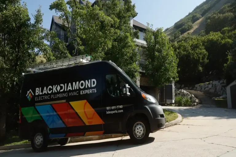 A Black Diamond Experts van sits on a driveway, ready to deliver trusted 24/7 plumbing, HVAC, electrical & drain service in Utah.