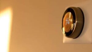 A smart thermostat on a beige wall set to 74°F, reflecting Black Diamond Experts’ reliable, 24/7 home comfort and repair service.