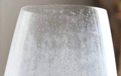 A cloudy wine glass with hard water stains, showing the importance of trusted local experts for spotless, safe home comfort—24/7.