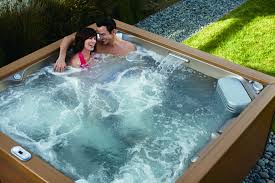 A couple enjoys peace of mind in an outdoor hot tub, thanks to Black Diamond Experts’ reliable home comfort and repair services.