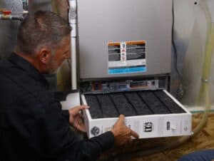 A skilled technician changes an HVAC air filter, ensuring safe, reliable comfort—Black Diamond Experts are Utah’s 24/7 home service pros.